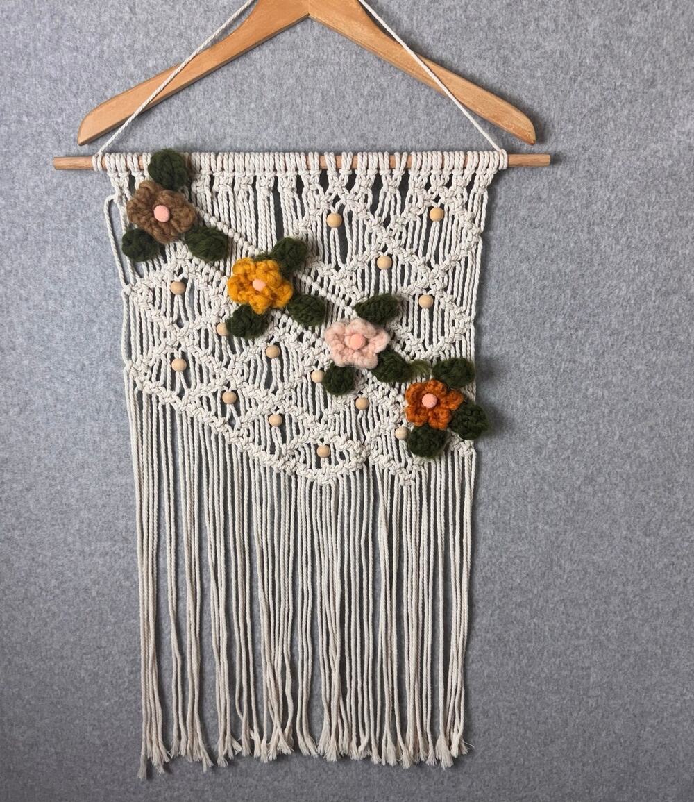 handmade boho-style macramé wall hanging crocheted flowers wooden beads fringe